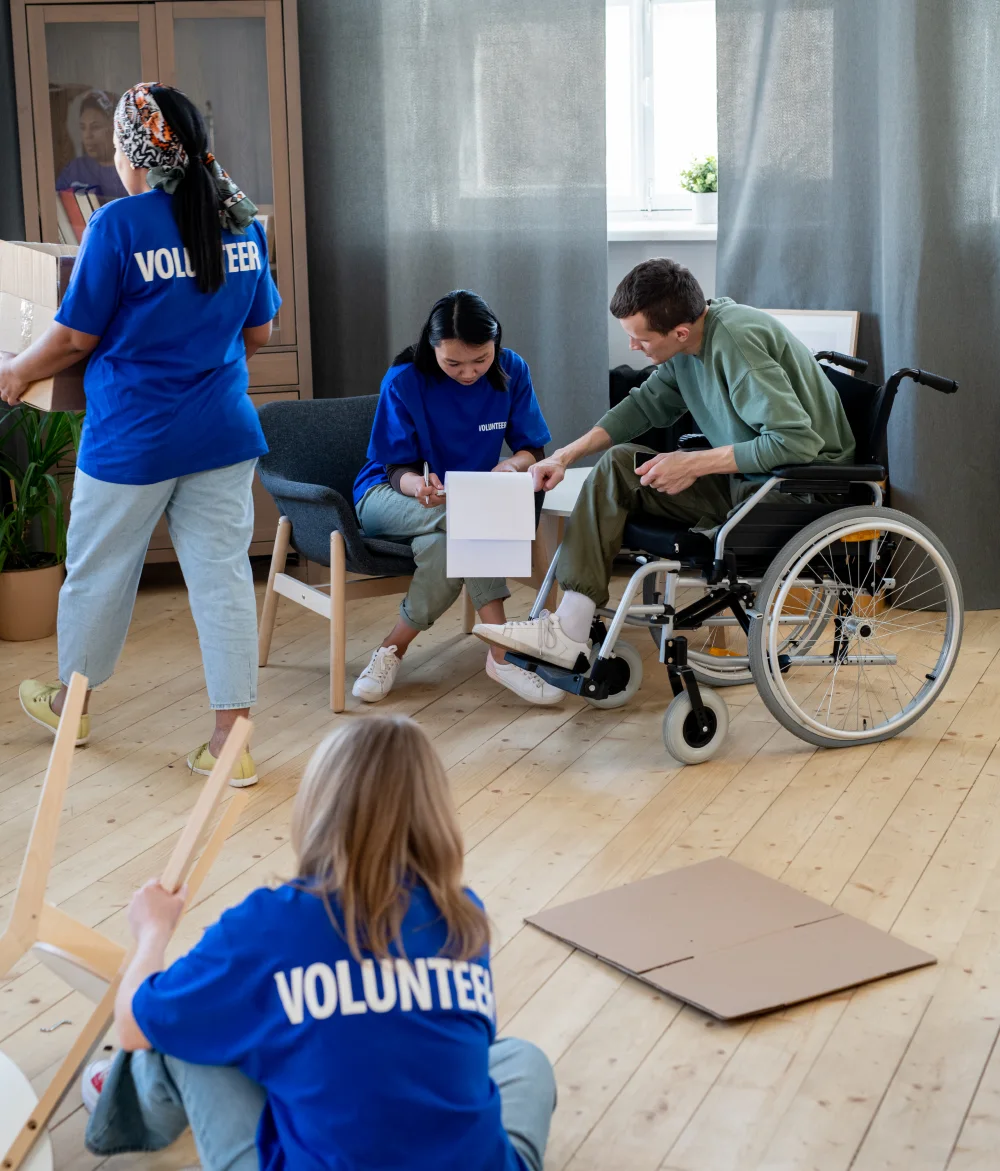 A group of volunteers moving boxes and looking at a checklist