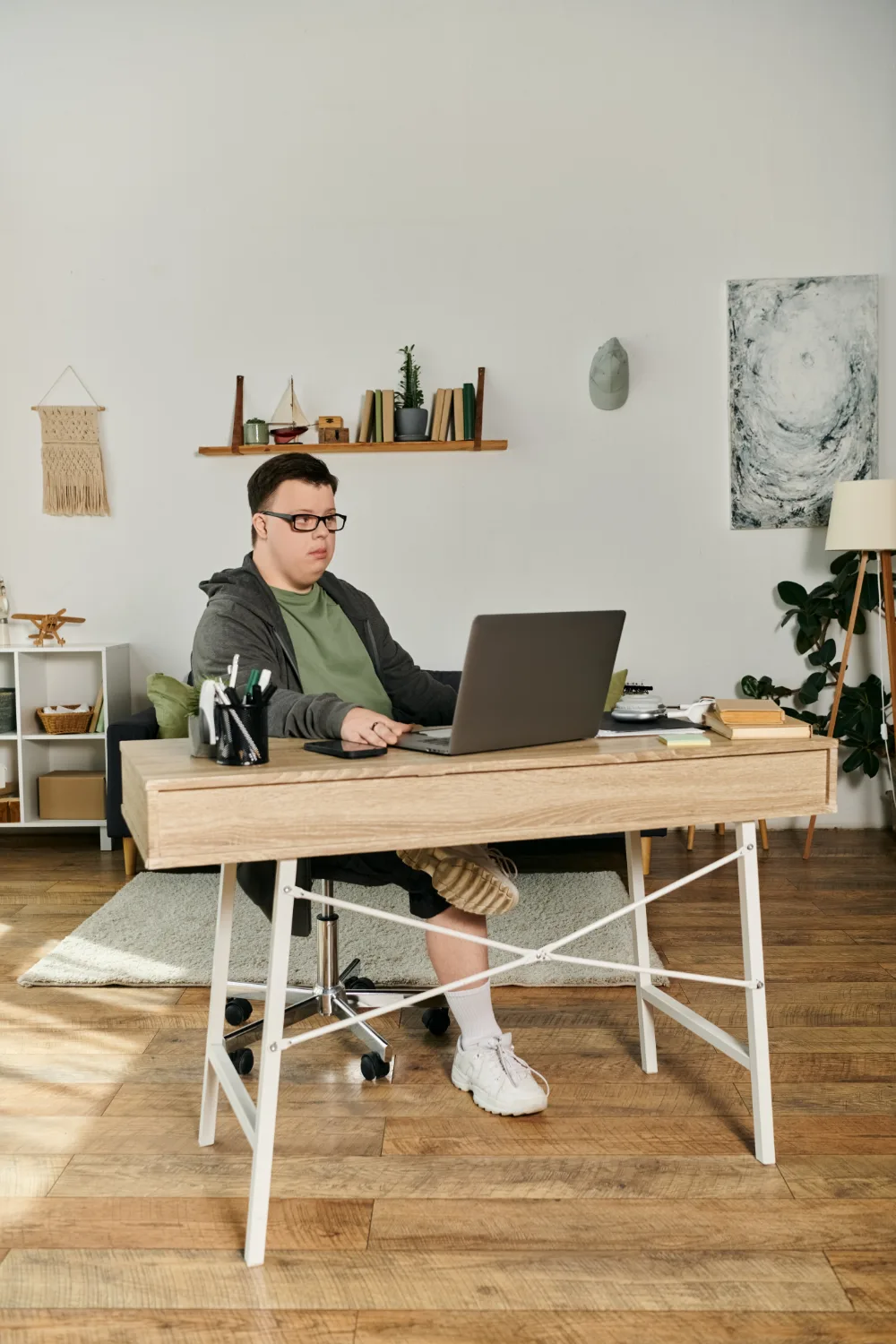 A young man browsing in a laptop in his home