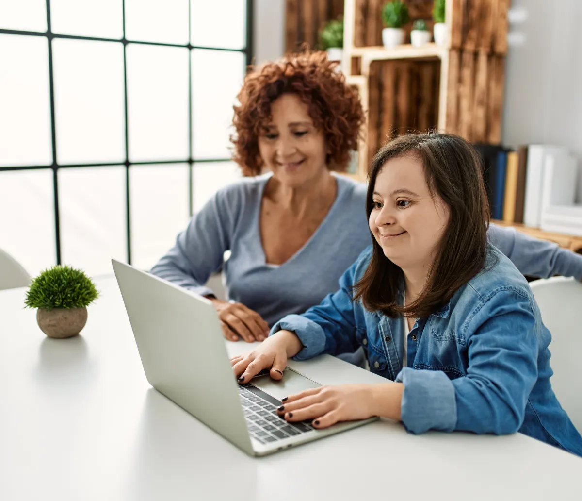 A young woman and mother browsing on a laptop