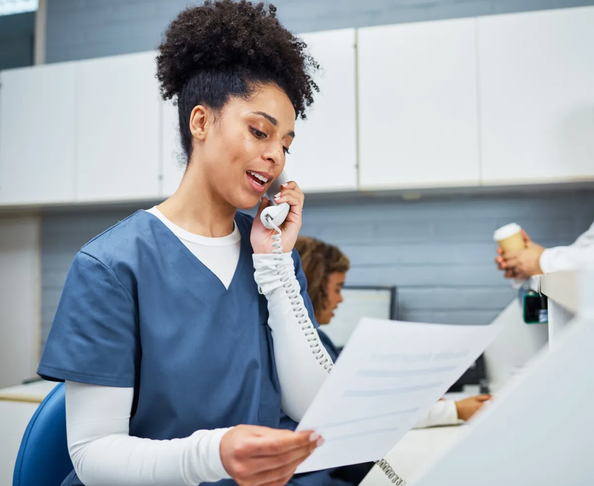 Younger female nurse making a phone call