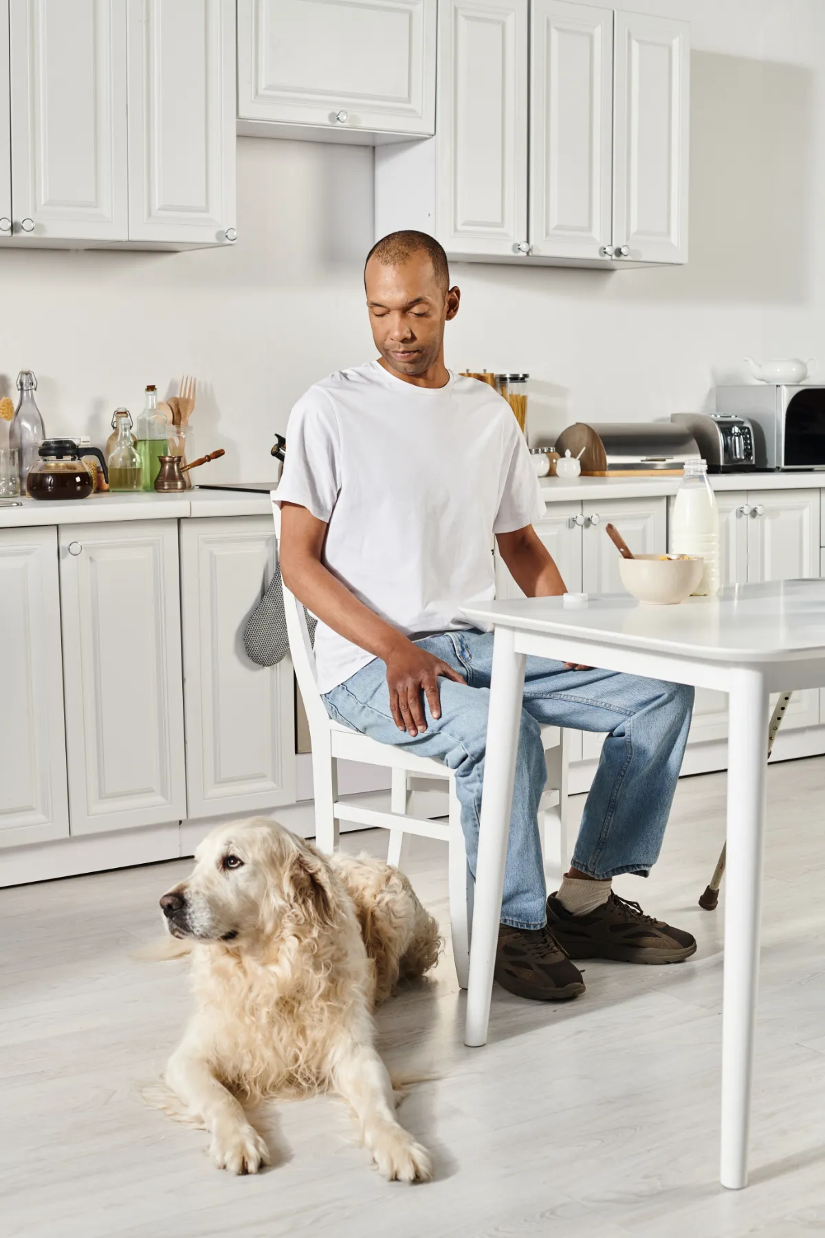 Man sitting at a kitchen table with his dog