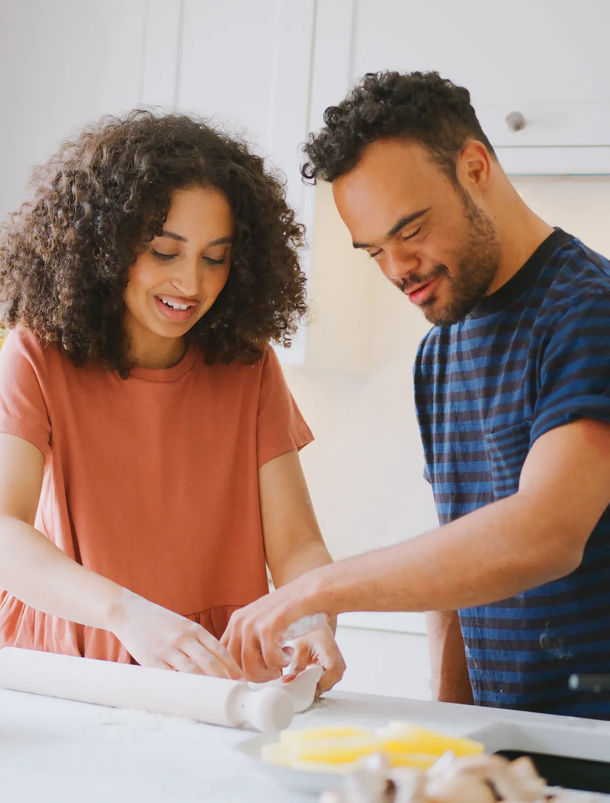 A man and his caretaker cooking in the kitchen